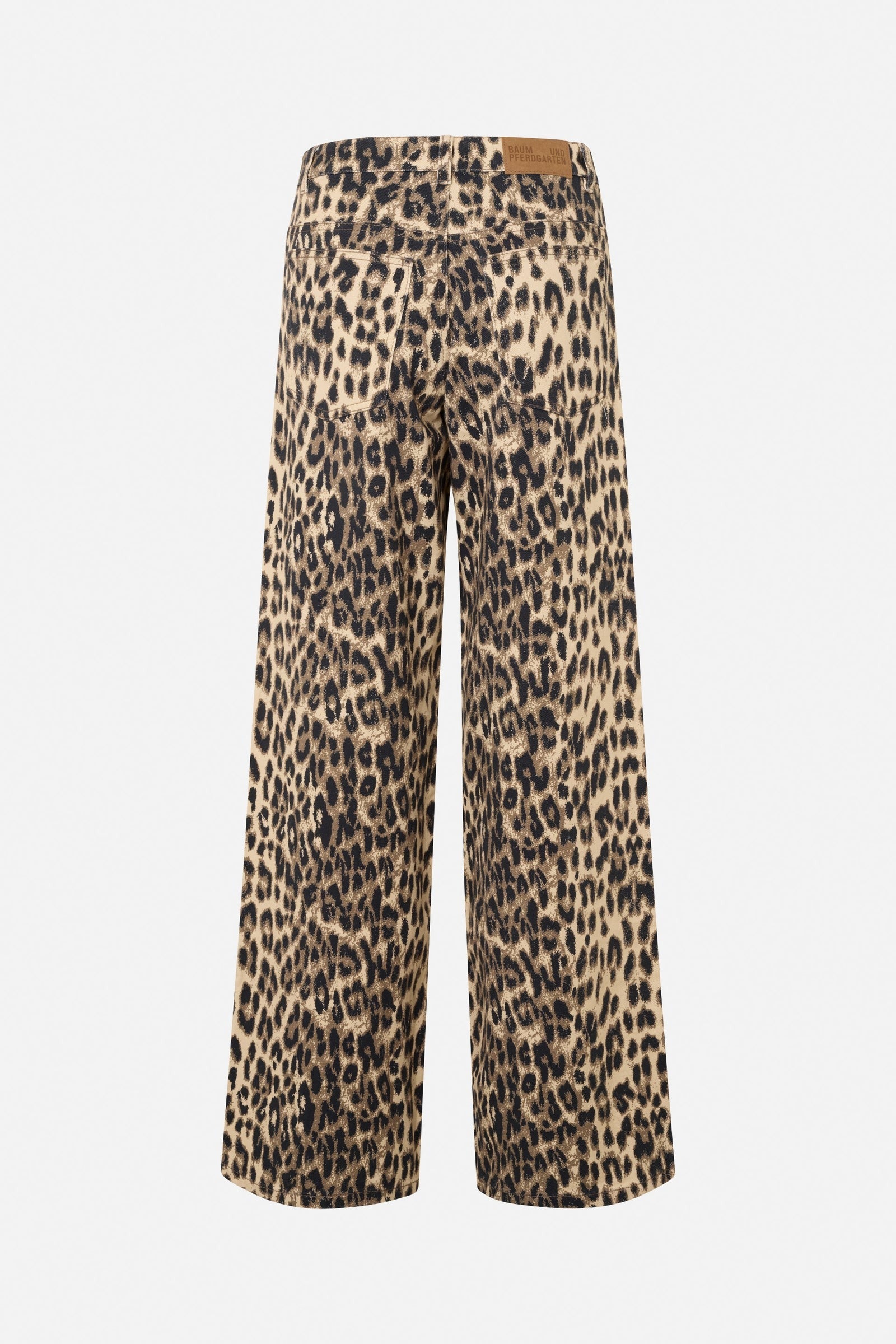 The Baum und Pferdgarten Nicette Jean is a pair of wide-leg jeans featuring a leopard print pattern. These jeans have a light background with dark, irregular spots, creating a typical animal print appearance. Made from organic cotton, they are finished off with a brown leather patch at the back waistband for added style.