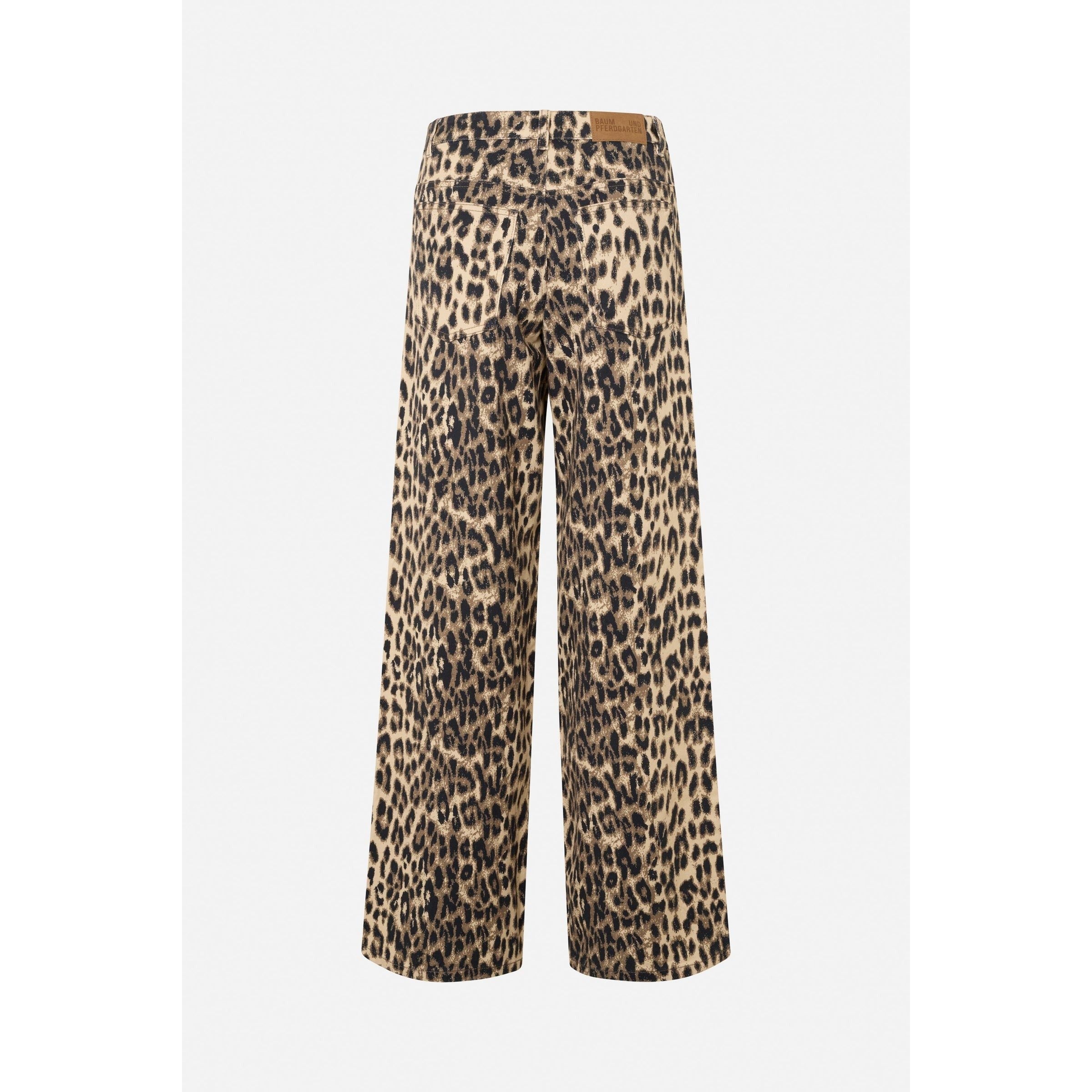 The Baum und Pferdgarten Nicette Jean is a pair of wide-leg jeans featuring a leopard print pattern. These jeans have a light background with dark, irregular spots, creating a typical animal print appearance. Made from organic cotton, they are finished off with a brown leather patch at the back waistband for added style.