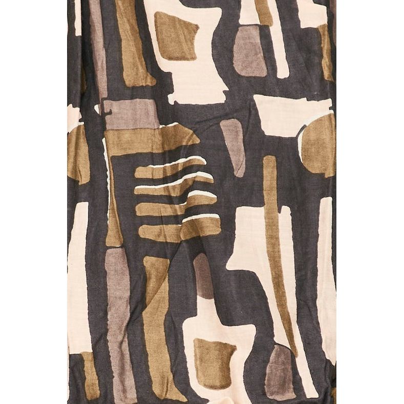 The Mirth Cassis Dress in Olive Labyrinth showcases a modern abstract design with asymmetrical shapes in brown, beige, black, and cream tones. It features vertical and horizontal lines for a geometric look on hand block printed 100% cotton poplin, set against a soft, textured background.