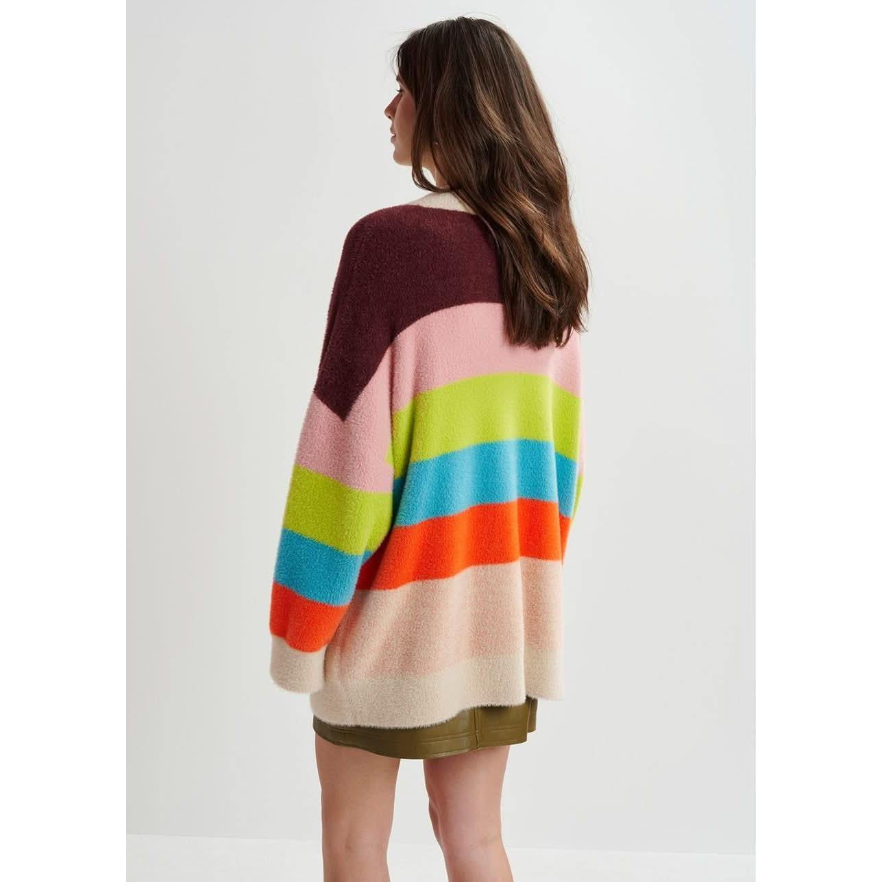 A woman wearing a multicolor striped fuzzy knitted cardigan by Essentiel Antwerp.