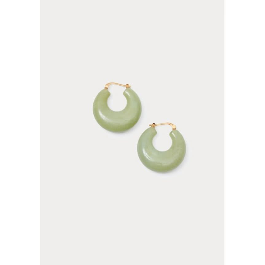 A pair of Rachel Comey Grass Earrings in Pear, featuring circular jade hoops with gold clasps on a plain background, thoughtfully crafted in Italy.