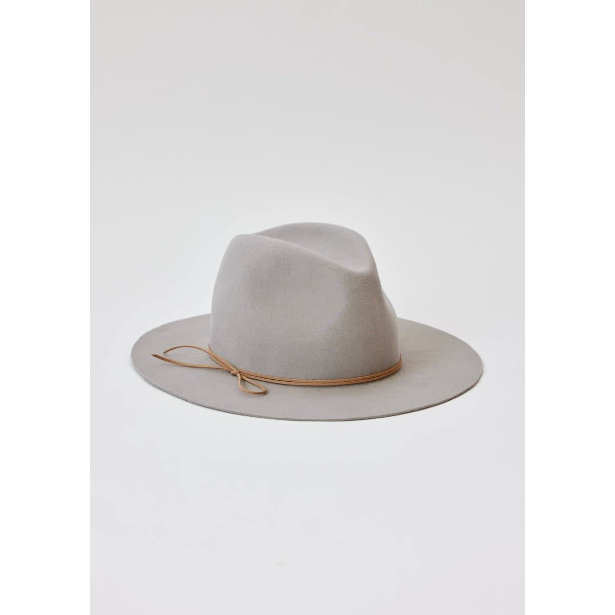 The Hat Attack Classic Amelia in light grey is a wool felt fedora expertly hand blocked and crafted in the USA. It features a wide brim adorned with a thin brown leather band and is elegantly showcased against a plain white background.