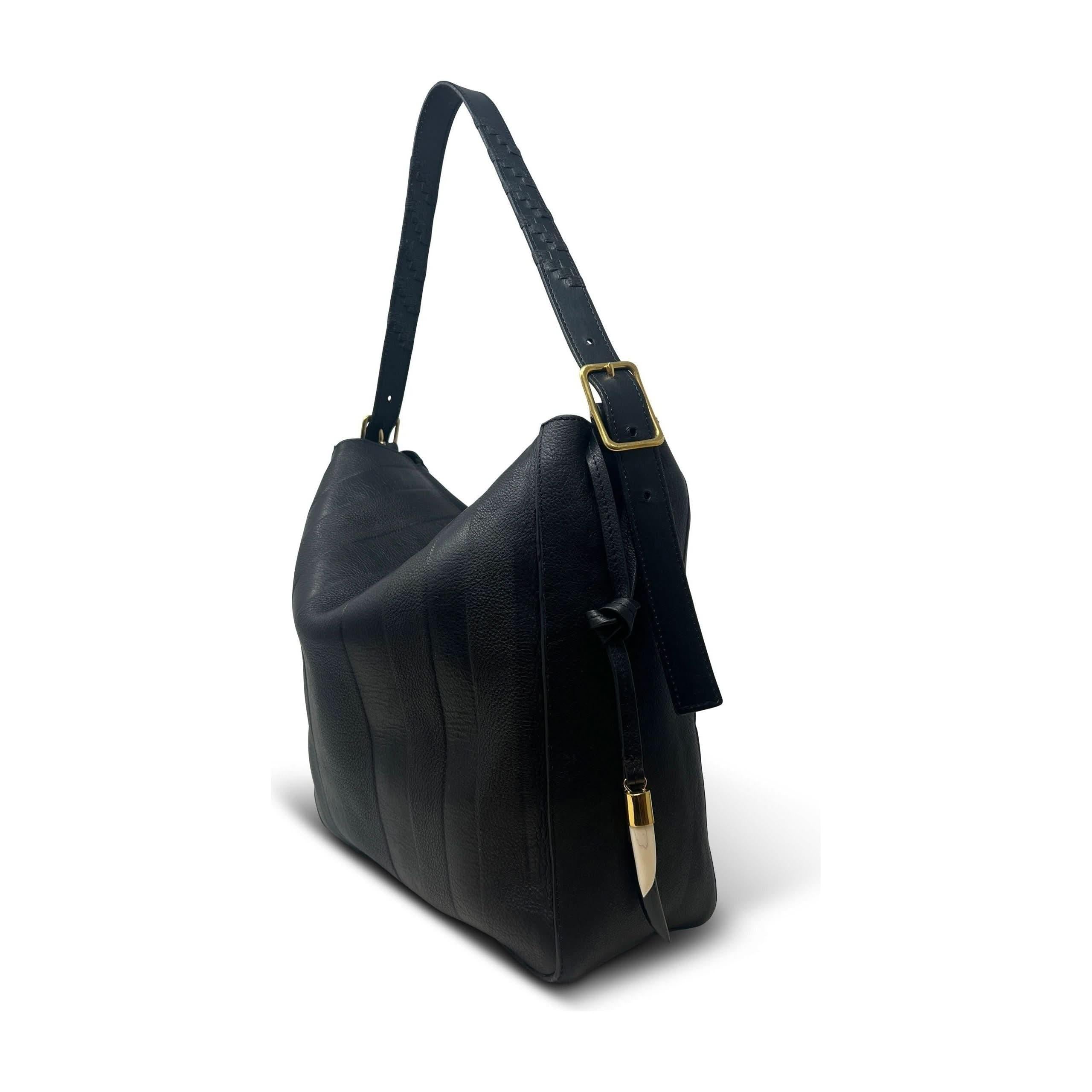 Introducing the Kempton & Co Hobo Black Heated Stripe by Kempton & Co, a sophisticated black leather shoulder bag featuring an adjustable handle and a gold buckle. This elegant bag boasts subtle vertical stitching and a gold accent on the zipper pull. Showcased at an angle to highlight its side and front profile, it is enhanced with a sleek magnetic closure for added elegance.