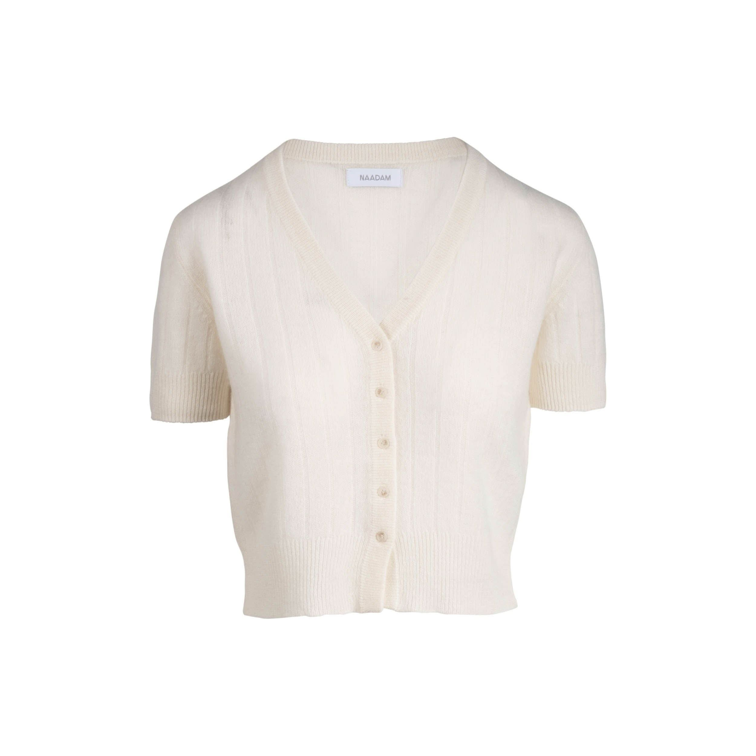 A white, short-sleeve cardigan made from luxurious cashmere with a ribbed design and V-neckline. It includes six buttons along the front and displays the "Naadam" label inside the collar.