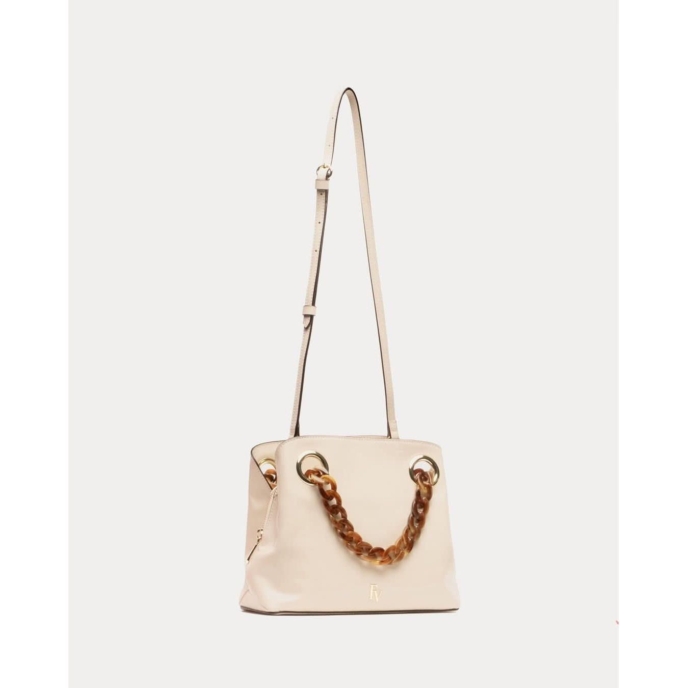 The Frances Valentine Skip Tote Crinkled Leather Oyster is a beige handbag made from crinkled leather, featuring a removable crossbody strap and a stylish tortoise chain handle. The chain showcases brown with gold accents that connect to gold eyelets on the bag. A small gold brand logo decorates the front, adding a touch of elegance.