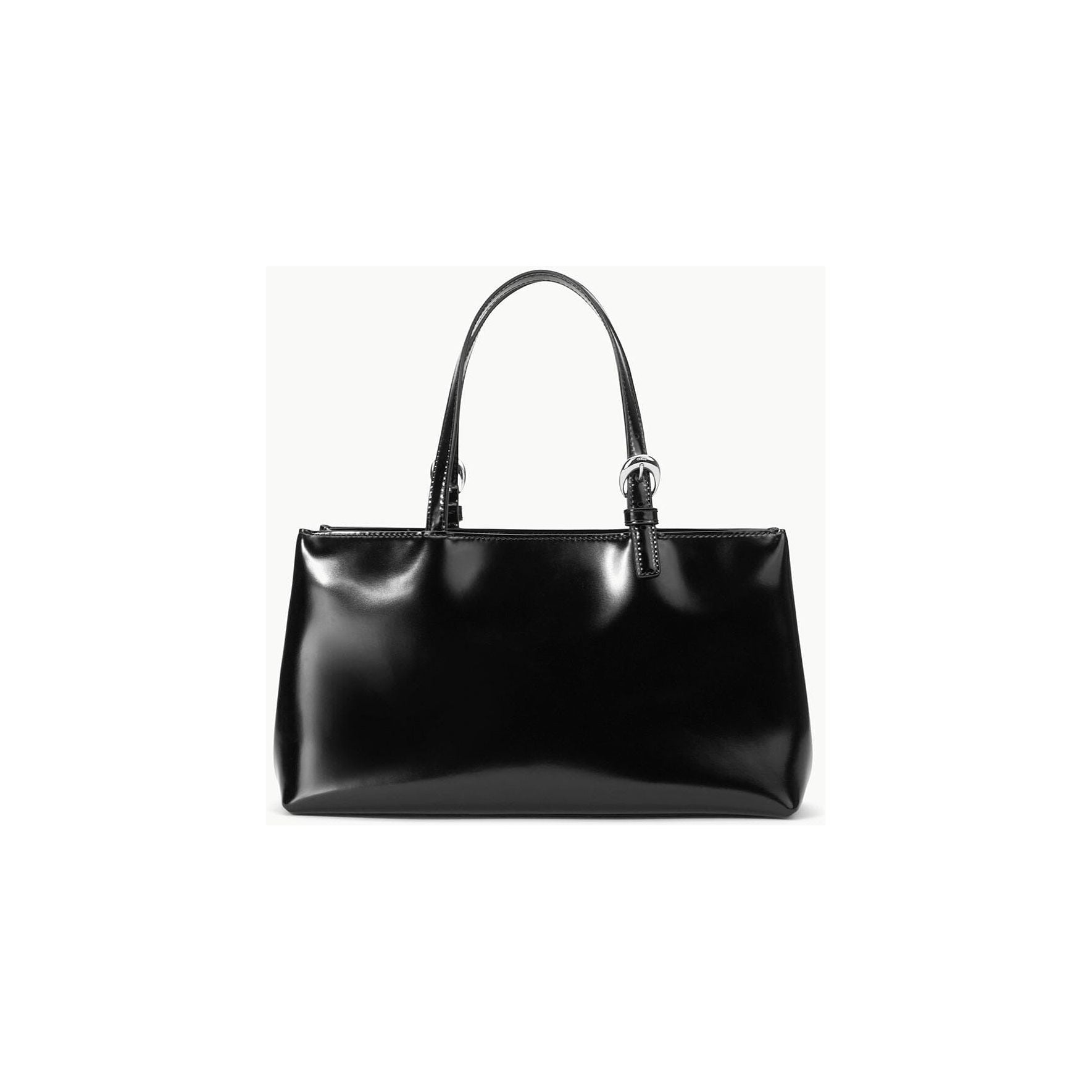 The Staud Brando Bag in black showcases a sleek and glossy leather finish against a light background. It features two short handles, accented with silver hardware, and a magnetic closure, embodying a minimalist and elegant design.