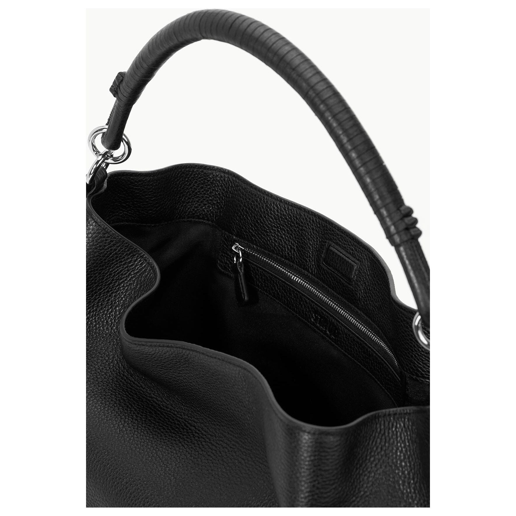 Close-up of an open Staud Perry Bag Black featuring a textured handle. The pebbled leather handbag showcases an unzipped main compartment with an interior zip pocket. Its elegant and functional design makes it ideal for those seeking a stylish yet practical hobo shoulder bag by Staud.