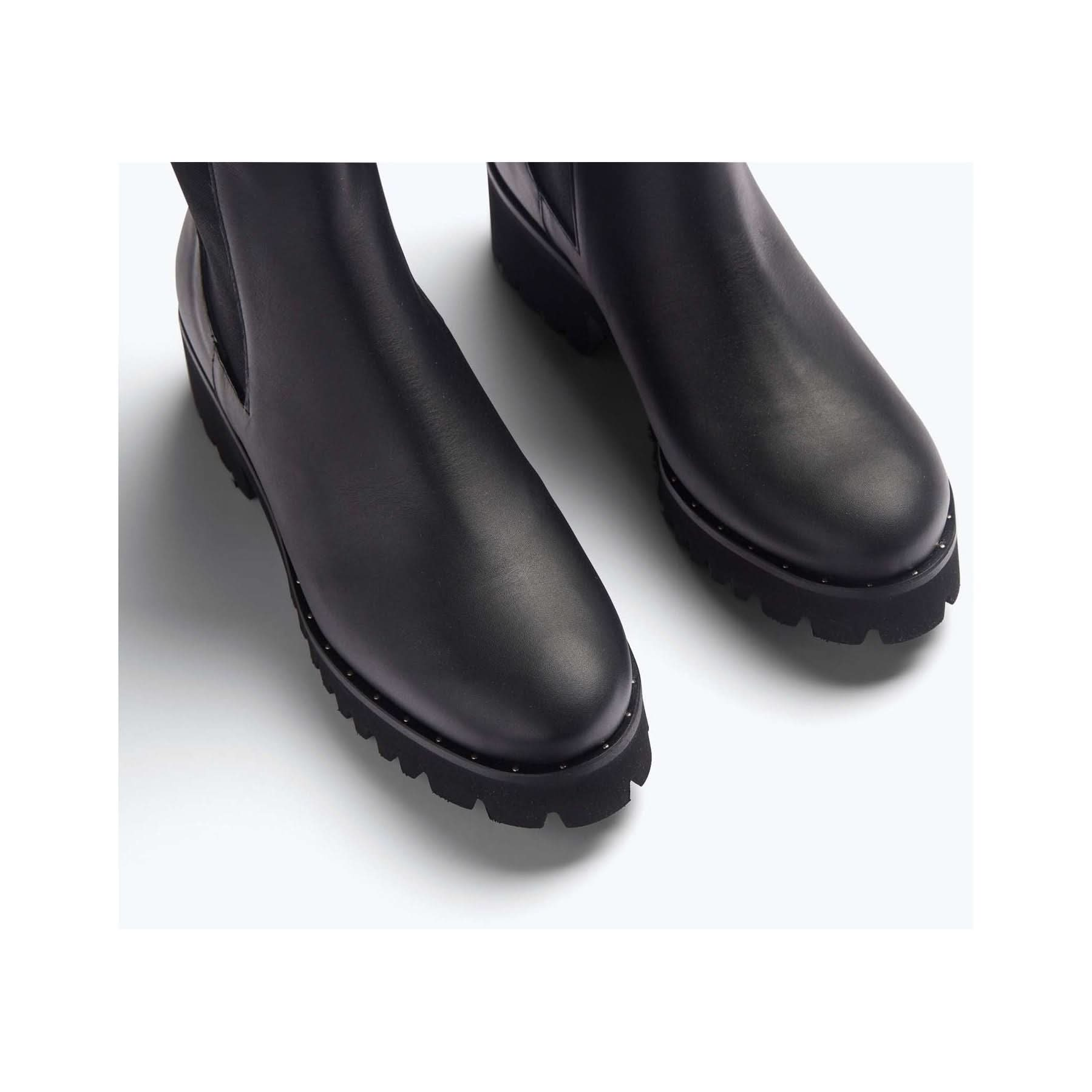 A close-up image of a pair of Freda Salvador Brooke Rain Resistant Boots displayed against a plain white background. Crafted from premium Italian leather, the black boots with rugged, chunky soles are shown from above, highlighting their smooth, matte finish and slightly rounded toes.