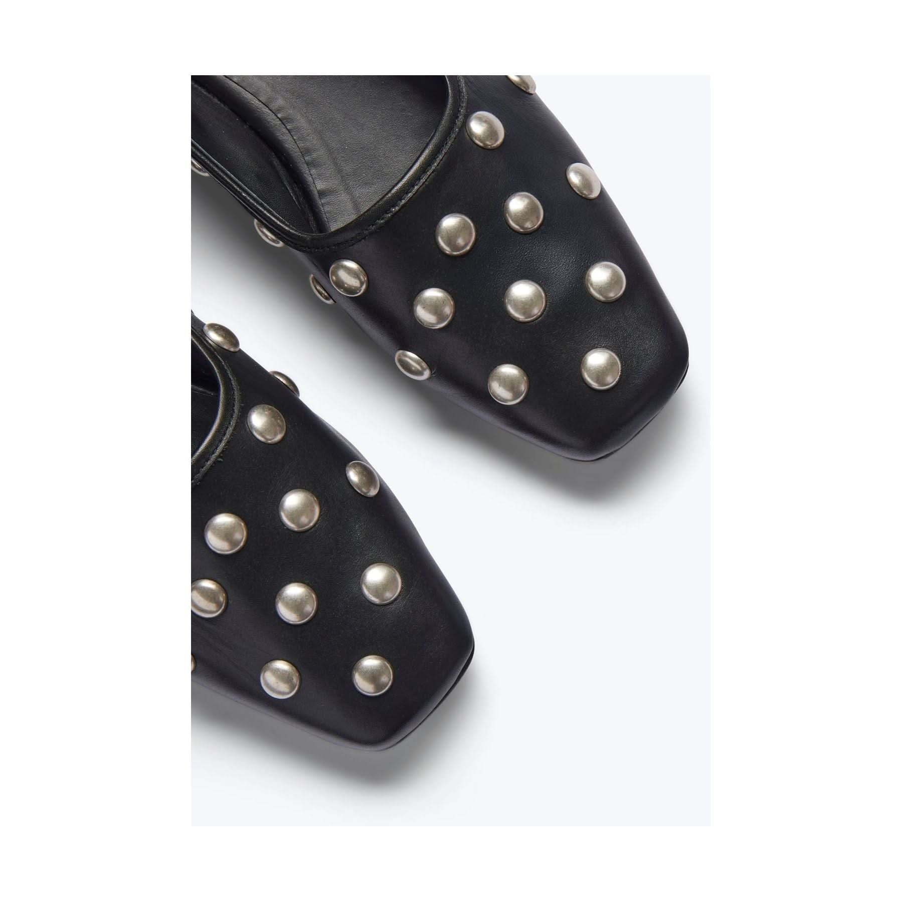 Close-up of the Freda Salvador Jessie Ballet Flat in black, featuring square toes and crafted from luxurious Italian leather. The flats are adorned with metallic studs arranged in rows and positioned on a plain white background.