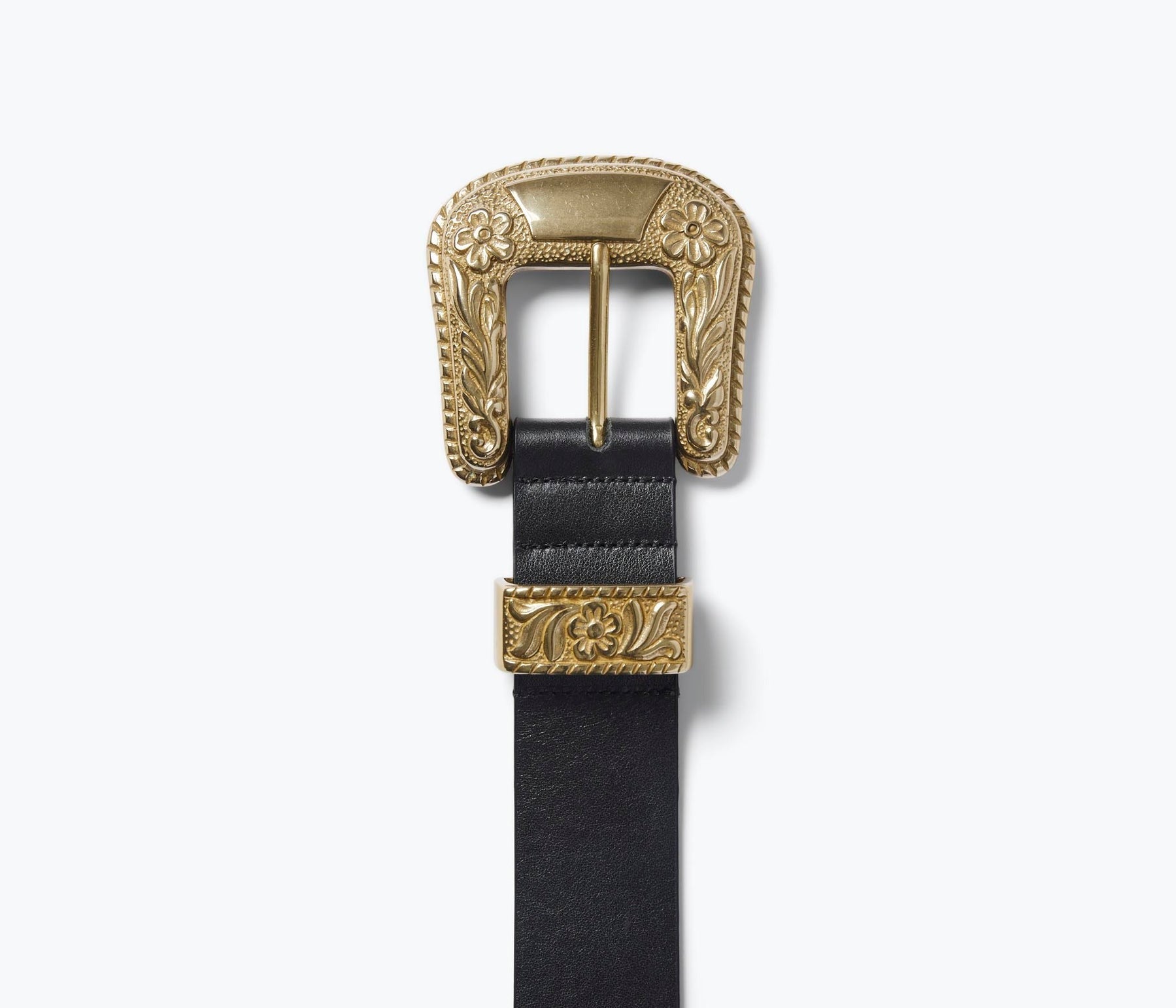 Introducing the Freda Salvador Laia Belt, an exquisite Italian black leather accessory adorned with an oversized brass buckle and matching belt loop. The buckle and loop feature intricate floral engravings, bestowing a vintage and elegant charm to this stunning natural waist belt.